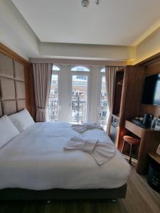 a bedroom with a large bed and a window at RIJJI HOTEL ISTANBUL OLD CiTY in Istanbul