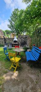 a picnic table and four chairs in a yard at Apartma Aria&Karra in Komen +13 photos