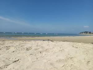 a sandy beach with the ocean in the background at Le Souffle Marin in Mesquer +4 photos