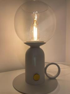 a glass lamp sitting on top of a table at UMA Home in Rome