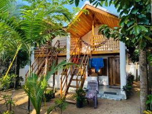 a house with a staircase leading up to it at Arugam Bay Holiday in Arugam Bay