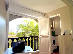 a room with a balcony with a washing machine at #Vacances en #Martinique in Sainte-Anne +12 photos