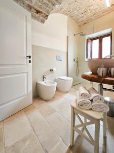 a bathroom with a tub and a sink and a toilet at Ddo e Dde dimore nr 56 in Alberobello