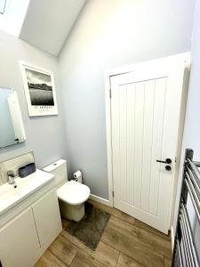 a bathroom with a white toilet and a sink at Rose Wynd Cottage-Close to beach in Crail +27 photos