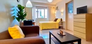 a living room with a couch and a bed at Charming Modern Condo in BGC in Manila
