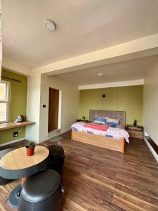a bedroom with a bed and a table and chairs at Lavish Stay at Boudha, Kathmandu, Heuju Residence in Kathmandu