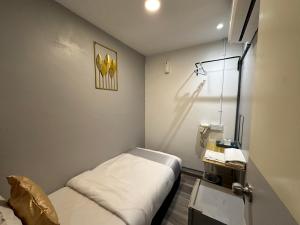 a small room with a small bed in it at SS Grey House Bukit Bintang in Kuala Lumpur