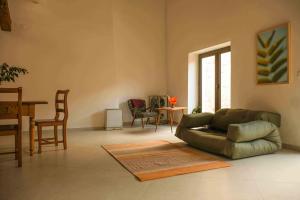 a living room with a couch and a table and chairs at Apartman Mak in Vodnjan