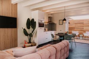 a living room with a couch and a table at Slapen aan Zee in Vlissingen