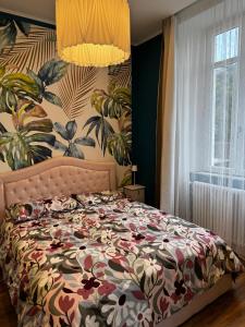 a bedroom with a bed with a floral bedspread at Como Lake Villa Galli & Pool in Castelmarte +117 photos