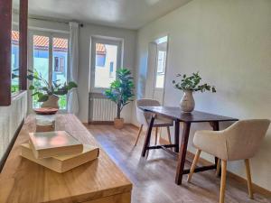 a living room with a table and chairs and windows at Alla Torre - Città Vecchia Locarno in Locarno