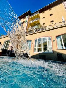 a water fountain in front of a building at Hotel La Pigna in Marina di Pietrasanta