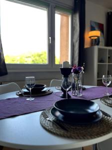 a table with plates and glasses on top of it at Chez Chantal - Zwischen Alltag & Auszeit in Halle an der Saale