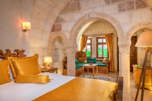 a bedroom with a king sized bed in a room at Onur Cave Cappadocia in Goreme