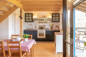 a kitchen with a table and a stove at Sielanka pod lipami in Krasnopol