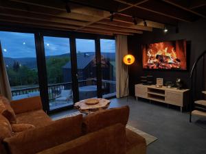 Posezení v ubytování Czarne Domki Krempna