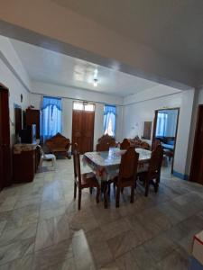 a living room with a table and chairs and a couch at Magdiwang Nature's View Lodge in Magdiwang