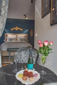 a table with a bottle of wine and a plate of food at Le Boudoir in Troyes