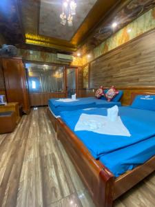a bed in a room with a wooden floor at hotel NGỌC QUÍ in Ho Chi Minh City +21 photos
