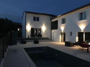 a house with a swimming pool at night at Ferienhausanlage Adria Oasis in Višnjan