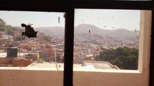 a person jumping in the air from a window at El Paraíso Escondido in Guanajuato