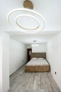 a bedroom with a bed in a white room at Apartmani Vukčević in Bar +44 photos