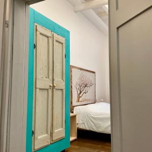 an open door in a room with a bed at Suites Cavallotti - Il Mandorlo in Orvieto