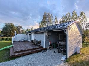 a building with a wooden deck next to a yard at Kril in Remniku