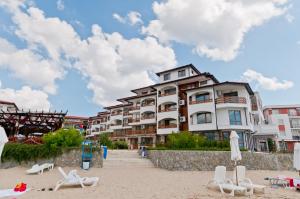 a hotel on the beach with lounge chairs and umbrellas at Robinzon Beach 3BD Lux apartment by Flat Mаnager in Elenite