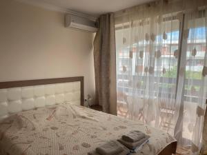 a bedroom with a bed with two towels on it at Robinzon Beach 3BD Lux apartment by Flat Mаnager in Elenite