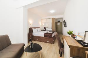 a hotel room with a bed and a living room at Hotel 219 Budva in Budva