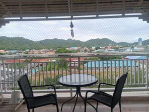 a table and chairs on a balcony with a view at Baan Klang condo in Hua Hin