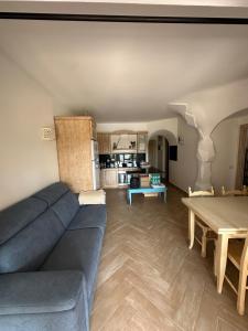 a living room with a blue couch and a table at PORTO CERVO Villa Girasole in Porto Cervo