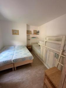 a bedroom with two bunk beds and a table at PORTO CERVO Villa Girasole in Porto Cervo