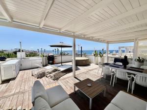 a living room with a patio with a view of the ocean at Mavitur Salento Apartments in Torre San Giovanni Ugento