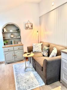 a living room with a couch and a table at Quaint Cottage in Kirkwall in Kirkwall