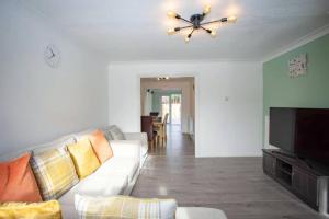 Μια τηλεόραση ή/και κέντρο ψυχαγωγίας στο Cozy 3-Bedroom Home in Luton