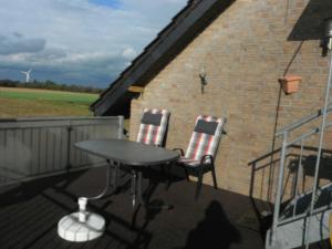 a table and two chairs sitting on a balcony at Ferienwohnung Thoebarth in Wachtendonk