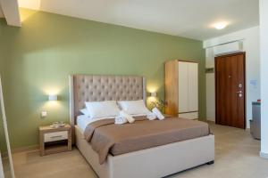 a bedroom with a bed with two towels on it at Sivota Seafront Studios in Sivota