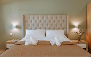 a bedroom with a large bed with two towels at Sivota Seafront Studios in Sivota