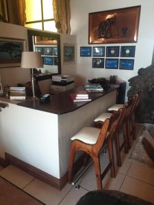 an office with a desk with chairs and a lamp at 125 on Van Buuren Road Guest House in Johannesburg