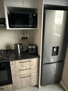 Kuchyň nebo kuchyňský kout v ubytování Table Mountain View Apartment