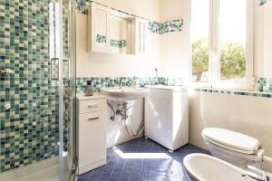 a bathroom with a toilet and a sink and a shower at Ravenna Retrò Vintage, City Flat 600 meters from the center in Ravenna +18 photos