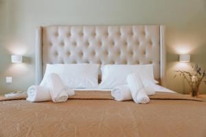 a bedroom with a bed with towels on it at Sivota Seafront Studios in Sivota