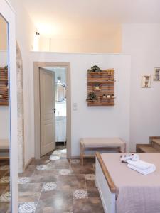a room with a bed and a table and stairs at Iliaxtida Apartment in Agia Paraskevi