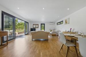 a living room with a table and chairs and a dining room at Independent rural detached annexe with free private Parking in Canterbury