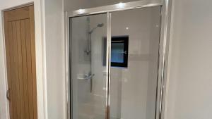 a shower with a glass door in a bathroom at NEW 1BD Contemporary Flat Upper Dunblane in Dunblane +3 photos