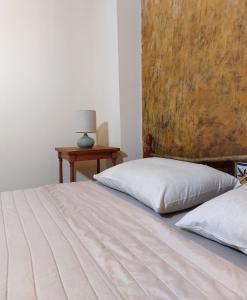 a bedroom with two beds and a table with a lamp at Iliaxtida Apartment in Agia Paraskevi