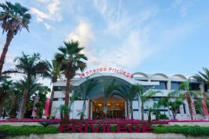 a hotel with palm trees in front of it at Leonardo Privilege Eilat Hotel - All inclusive in Eilat