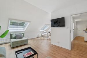 a living room with a couch and a tv at Dachgeschoss Traum Wohnung Ronsdorf 3 Zimmer in Wuppertal